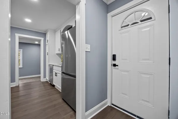 a view of a hallway with wooden floor