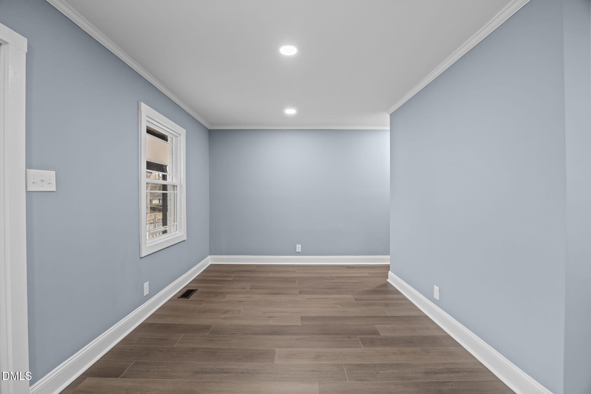 3000 Brentwood Road Raleigh, NC 27604 - Photo 28 of 44 a view of an empty room with wooden floor and a window