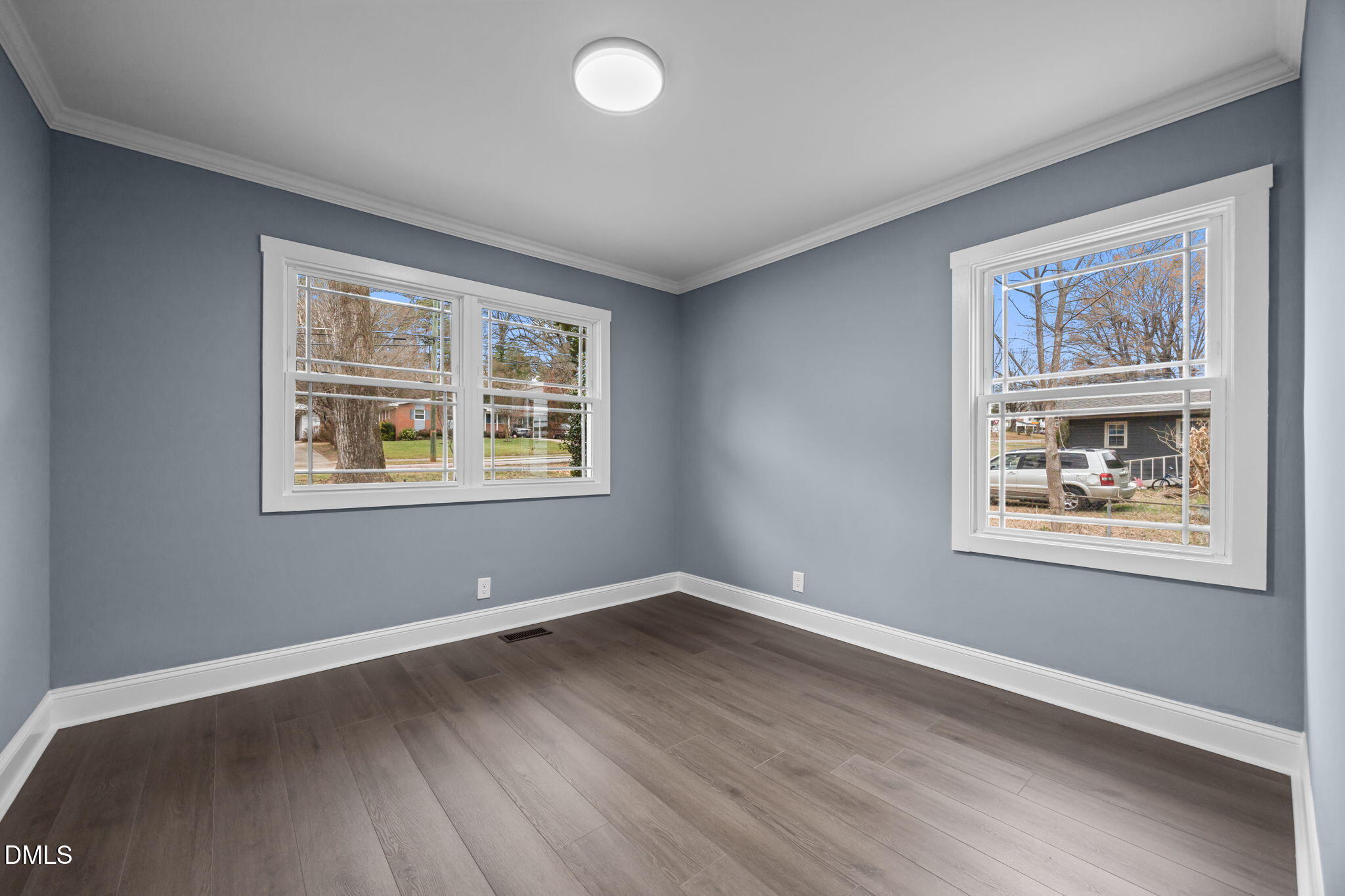 3000 Brentwood Road Raleigh, NC 27604 - Photo 33 of 44 a view of an empty room with window and wooden floor