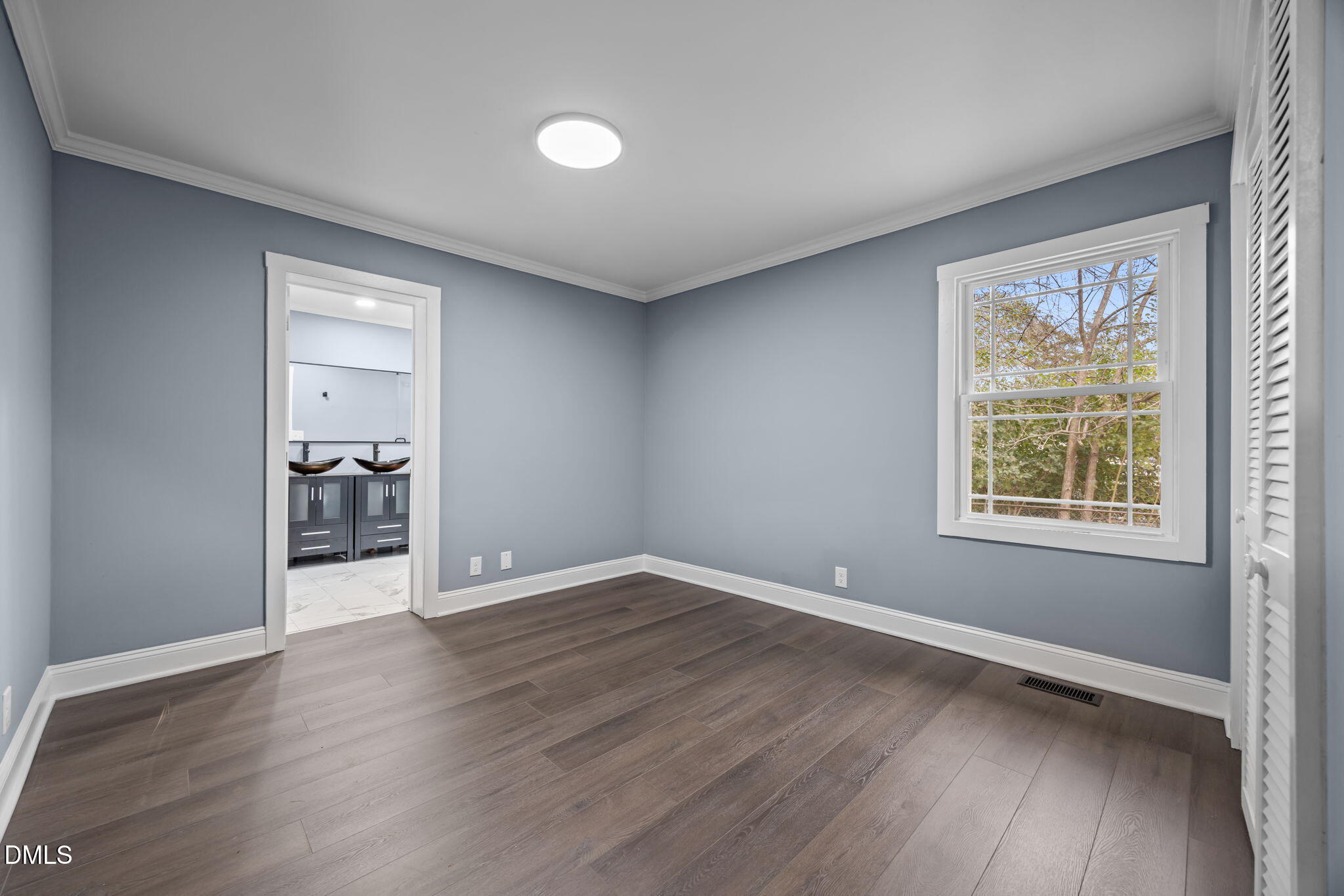 3000 Brentwood Road Raleigh, NC 27604 - Photo 35 of 41 an empty room with wooden floor and a window