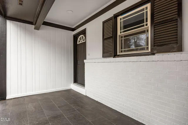 a view of a small house with a yard