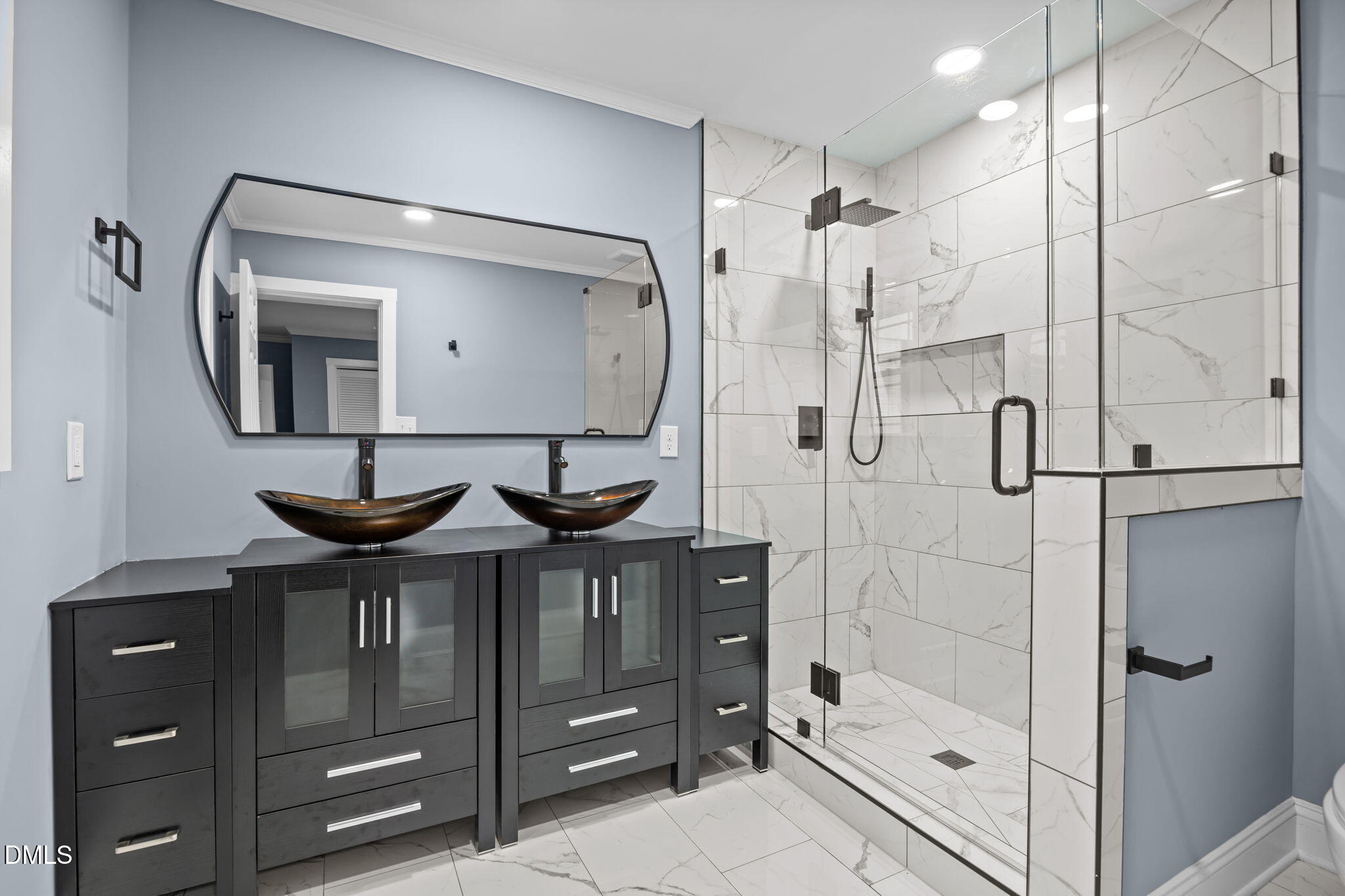 3000 Brentwood Road Raleigh, NC 27604 - Photo 40 of 44 a bathroom with a mirror sink and glass door shower