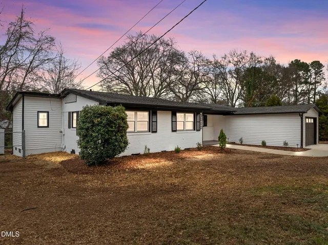 a view of a house with a yard and garage