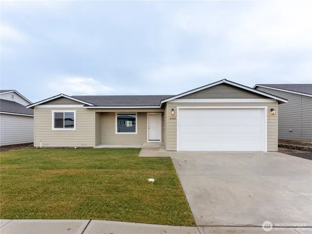 a view of a house with a yard and garage