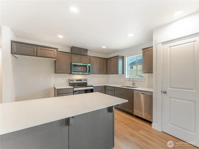 a kitchen with cabinets and stainless steel appliances