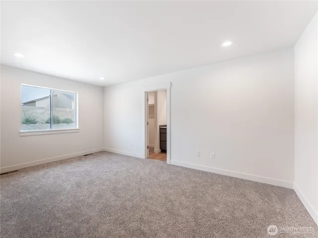 an empty room with windows and closet