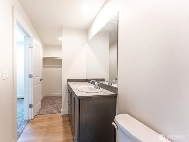 a bathroom with a sink toilet and mirror