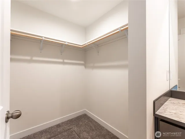 a view of walk in closet with empty racks