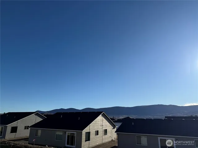 a view of houses with a city skyline