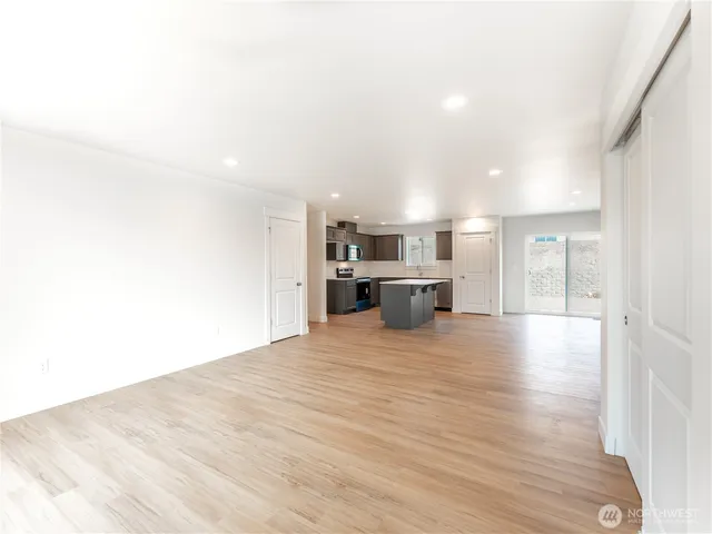 a view of a kitchen with a sink and a refrigerator