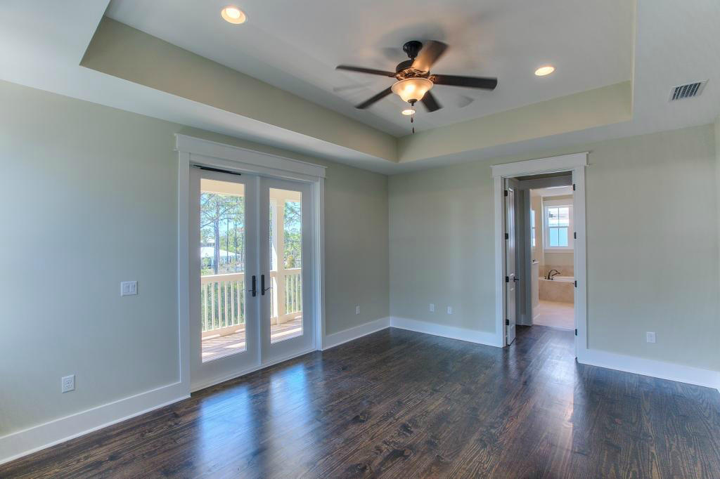 43 Flatwoods Forest Loop Santa Rosa Beach, FL 32459 - Photo 13 of 25 a view of an empty room with wooden floor and a window
