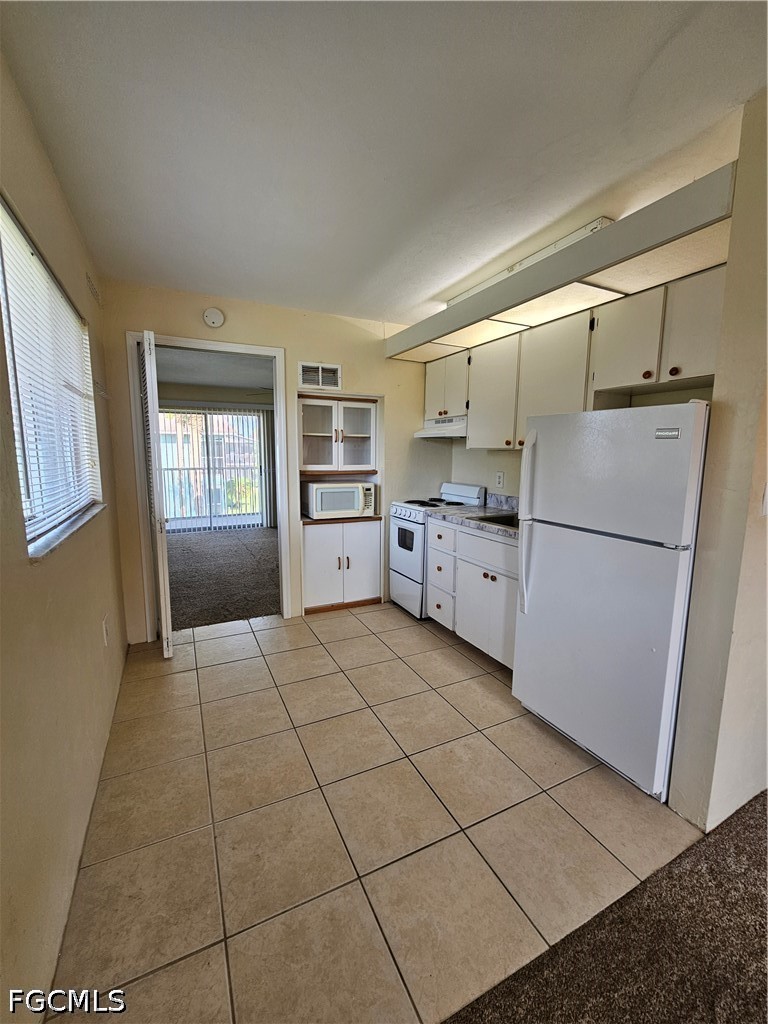 8101 Country Road, Unit 201 Fort Myers, FL 33919 - Photo 7 of 34 a kitchen with granite countertop a refrigerator and a stove top oven