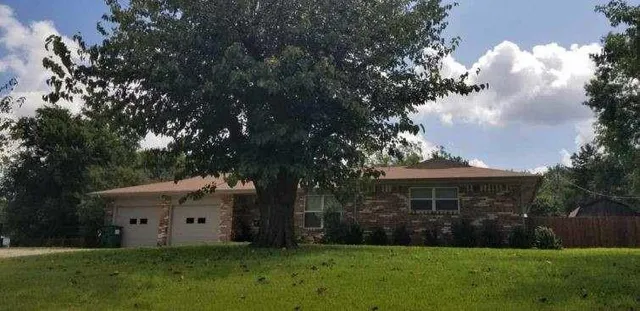 a view of house with backyard