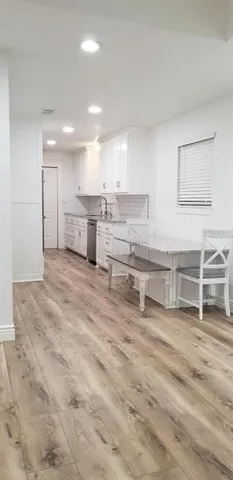 a view of kitchen with stainless steel appliances cabinets and living room view