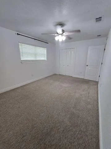 a view of empty room with fan