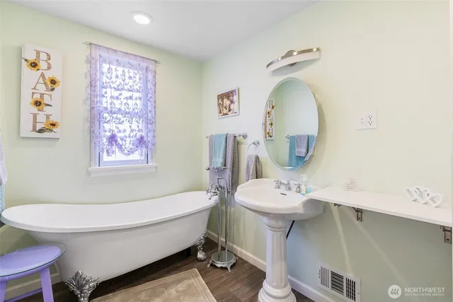 a bathroom with a sink mirror and toilet