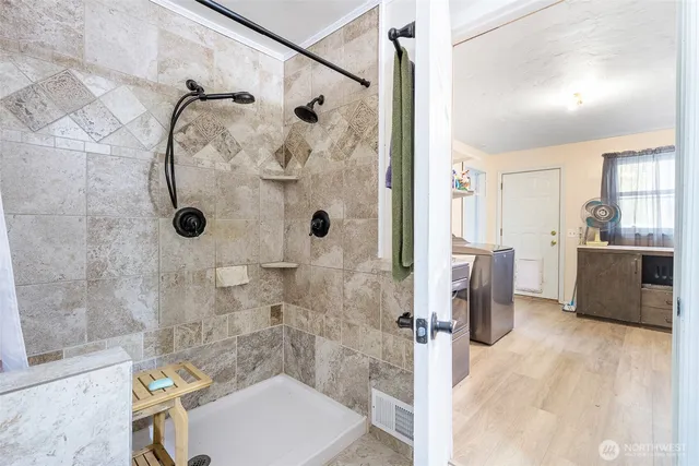 a bathroom with a sink toilet double vanity and shower