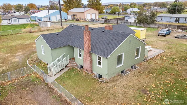 a view of a house with a yard and sitting area