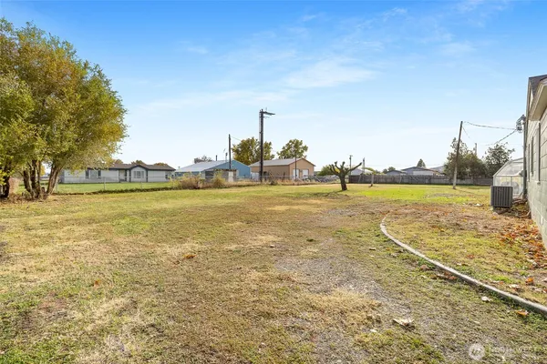 a view of a field with an trees