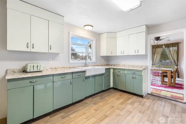 a kitchen with a sink cabinets and a window