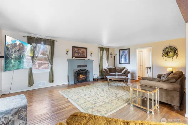 a living room with furniture and a fireplace