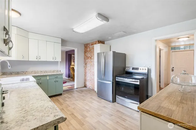 a kitchen with a refrigerator sink and stove