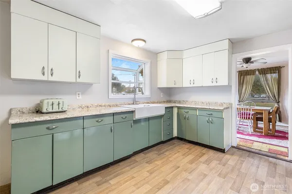 a kitchen with a sink cabinets and a window
