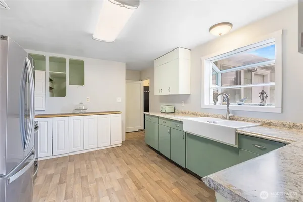 a kitchen with a sink cabinets and window
