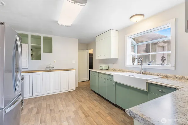 a kitchen with a sink cabinets and window