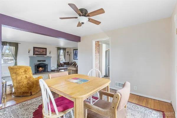 a dining room with furniture a rug and a fireplace