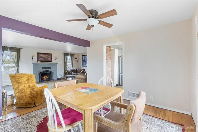 a dining room with furniture a rug and a fireplace