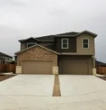 a front view of a house with a garage