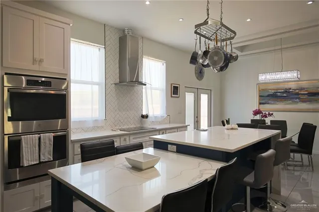 a large kitchen with a table and chairs