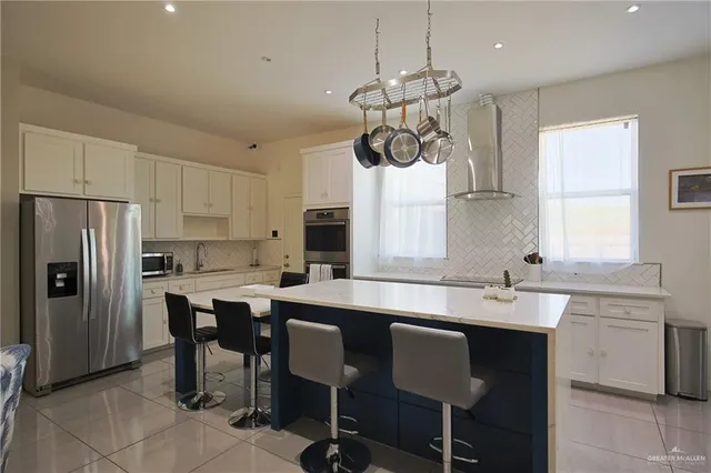 a kitchen with a center island appliances and cabinets