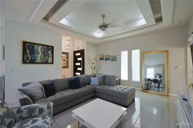 a living room with furniture and a view of bathroom