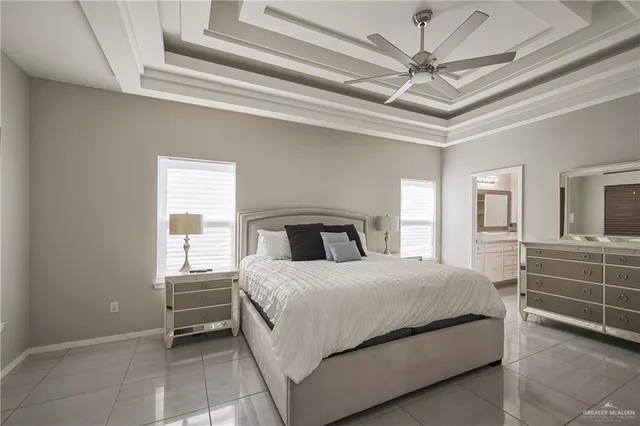 a bedroom with a large bed and a ceiling fan