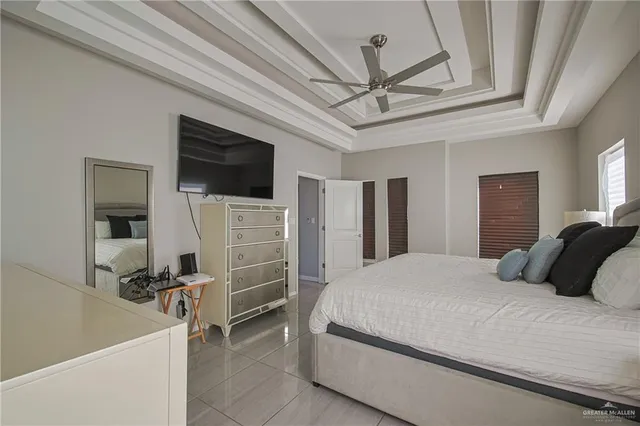 a bedroom with a bed a television and dresser