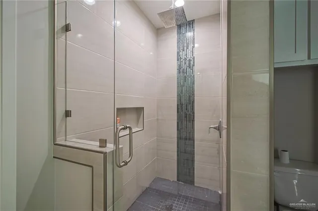 a bathroom with a shower and a sink