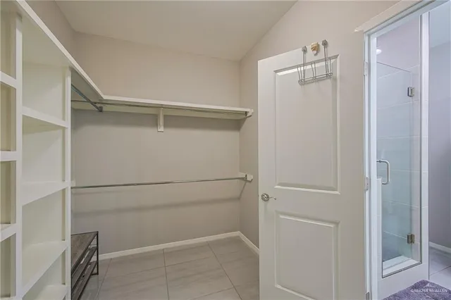 a view of walk in closet with empty racks