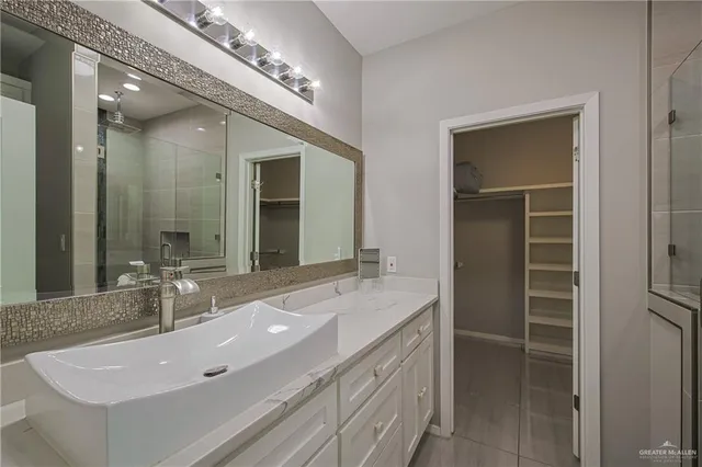 a bathroom with a double vanity sink and a mirror