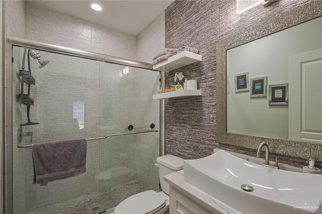 a bathroom with a sink toilet and shower