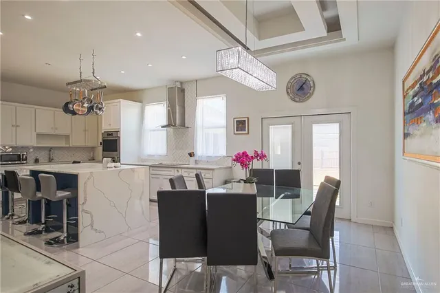 a kitchen with kitchen island stainless steel appliances a dining table and chairs