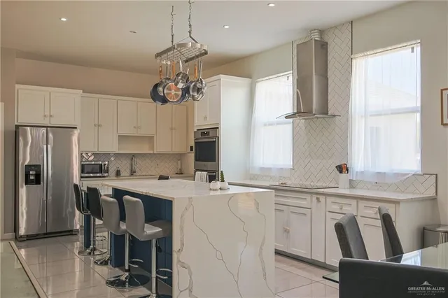 a kitchen with kitchen island granite countertop a sink a center island and cabinets