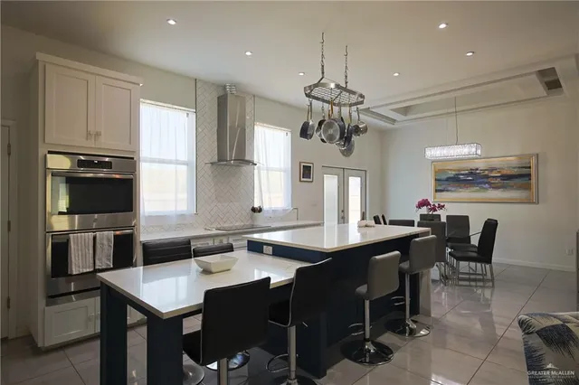 a large kitchen with a table and chairs