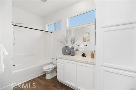 a bathroom with a bathtub shower sink vanity and toilet