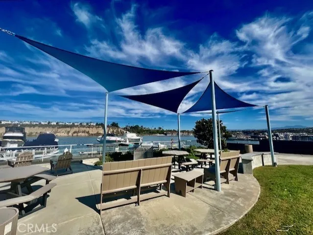 a view of a patio with a table and chairs under an umbrella