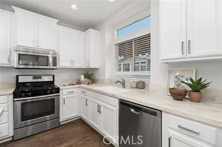 a kitchen with a sink stove and microwave
