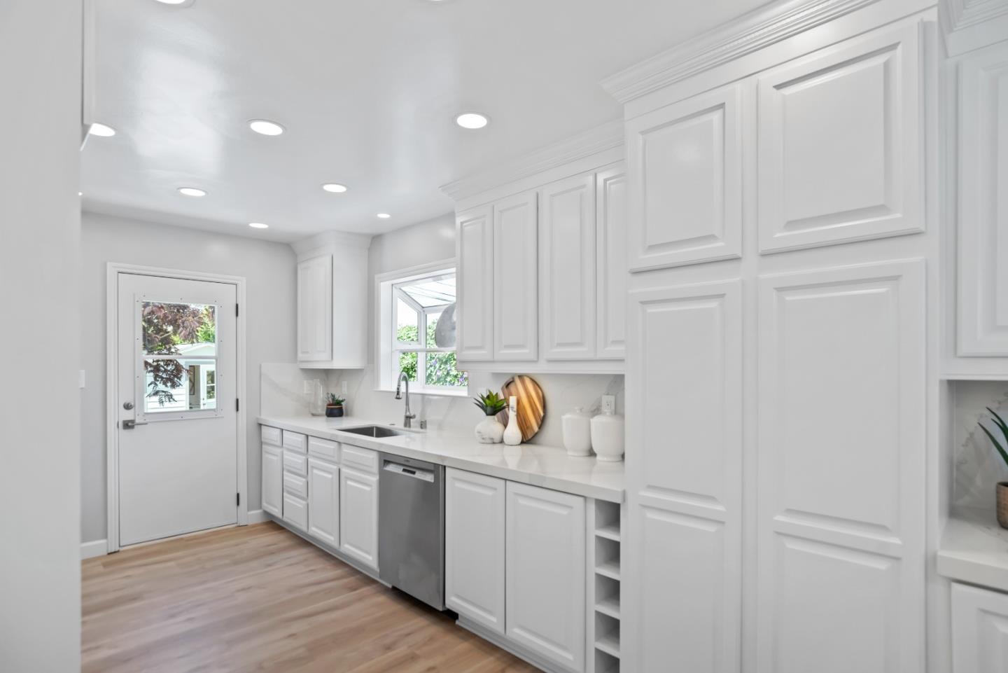 967 Chelan Drive Sunnyvale, CA 94087 - Photo 11 of 38 a kitchen with a sink window and cabinets