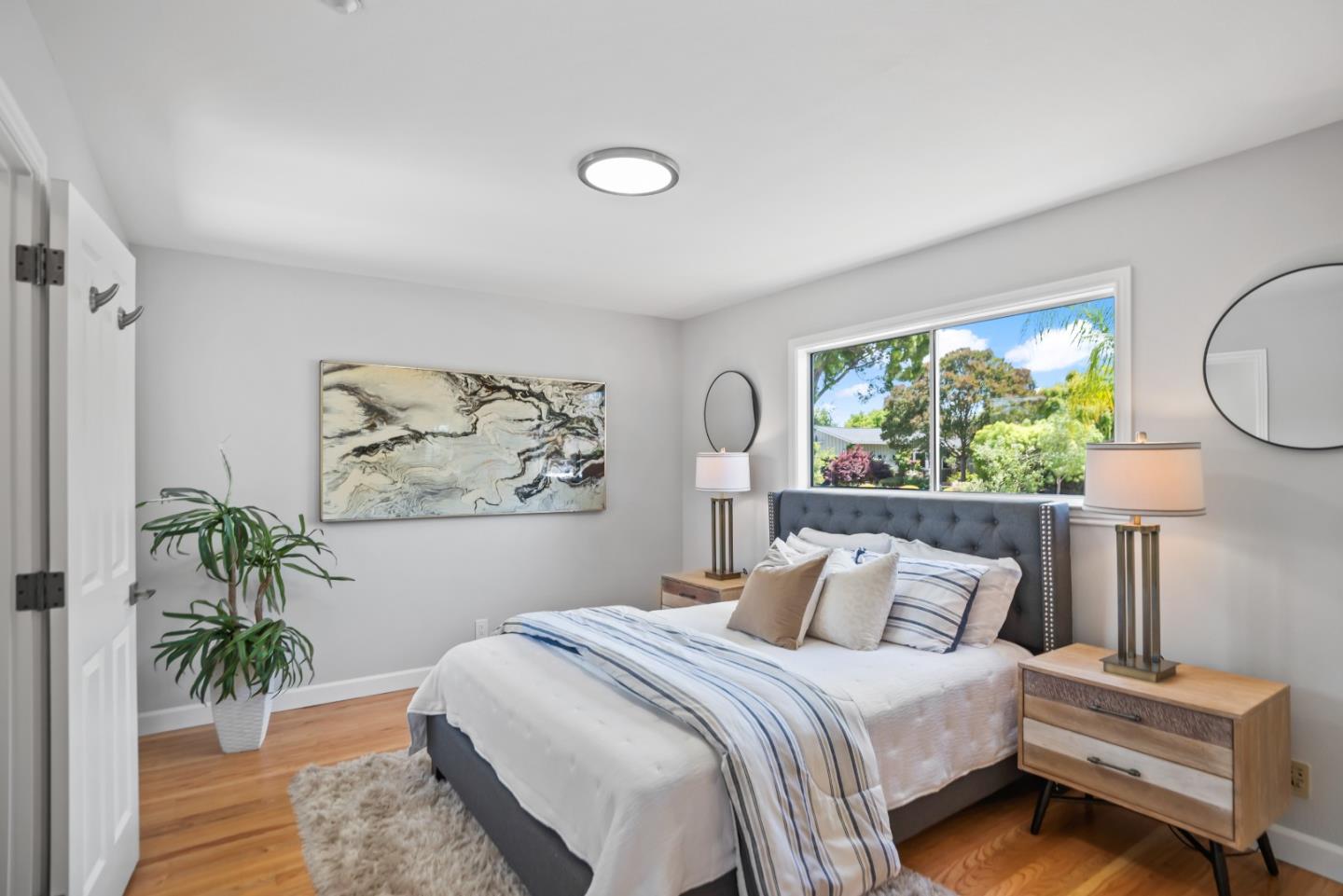967 Chelan Drive Sunnyvale, CA 94087 - Photo 17 of 38 a bedroom with a large bed and a potted plant