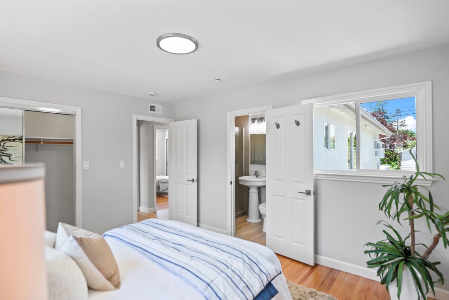 967 Chelan Drive Sunnyvale, CA 94087 - Photo 18 of 38 a bedroom with a large bed and a potted plant